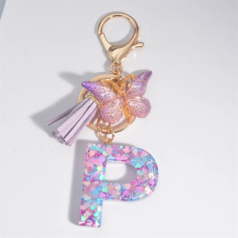 Color: Champagne - Fashion Tassel Butterfly 26Letter Keychain Colorful Love Heart Filled Resin Alphabet Keyring Women Girls Car Bag Phone Pendant