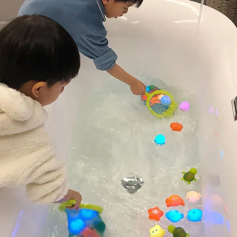 Color: black - Baby Cute Animals Bath Toy Swimming Water LED Light Up Toys Soft Rubber Float Induction Luminous Frogs for Kids Play Funny Gifts