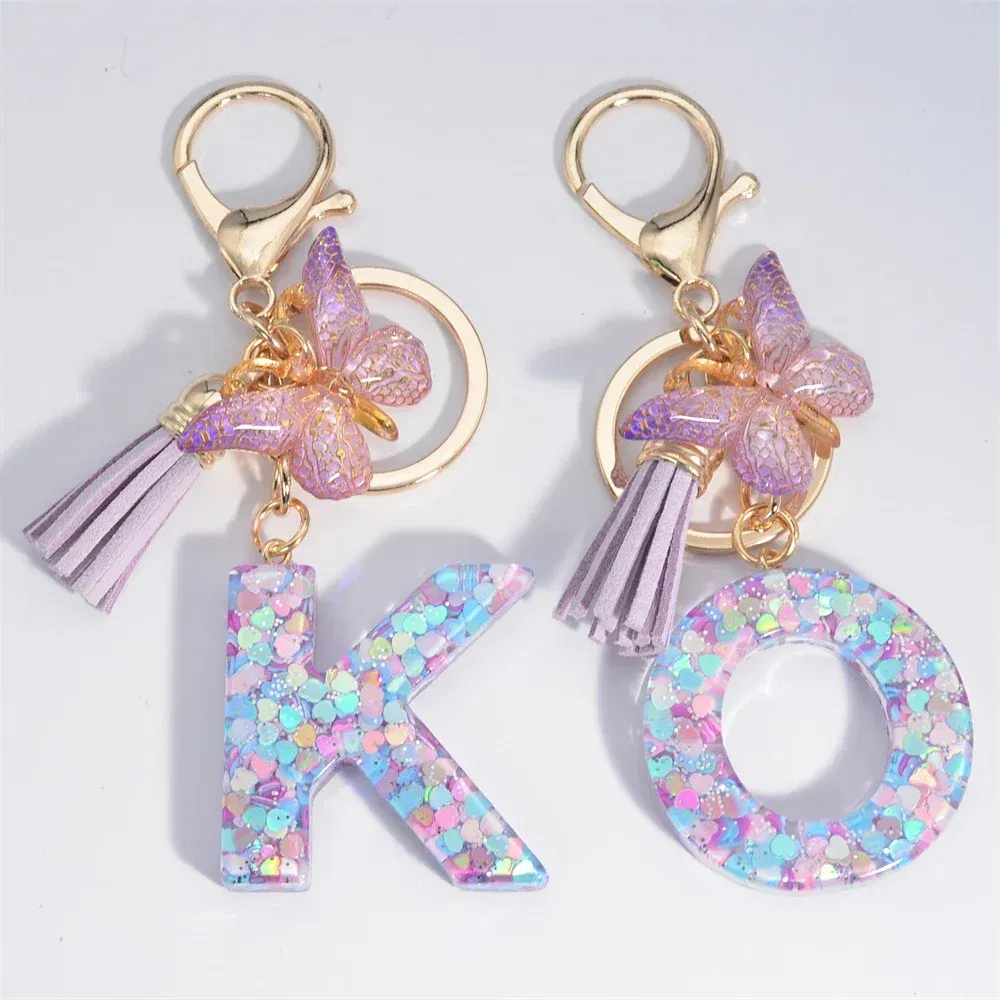 Color: Yellow - Fashion Tassel Butterfly 26Letter Keychain Colorful Love Heart Filled Resin Alphabet Keyring Women Girls Car Bag Phone Pendant