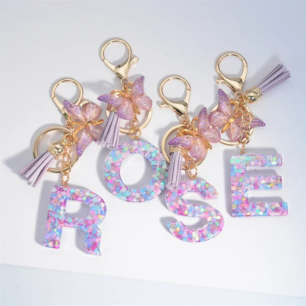 Color: Blue - Fashion Tassel Butterfly 26Letter Keychain Colorful Love Heart Filled Resin Alphabet Keyring Women Girls Car Bag Phone Pendant