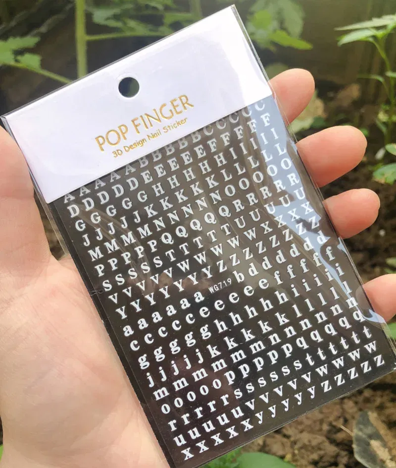 Color: WHITE - 1PCS New English Alphabet Nail Stickers Multi-Color Laser Reflective Nail Slider Art Cool Text Nail Kit