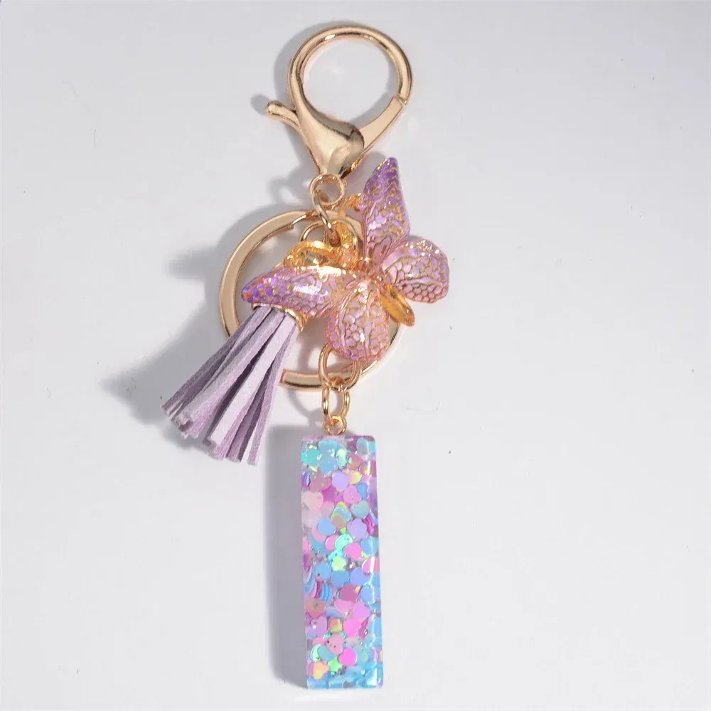 Color: PURPLE - Fashion Tassel Butterfly 26Letter Keychain Colorful Love Heart Filled Resin Alphabet Keyring Women Girls Car Bag Phone Pendant